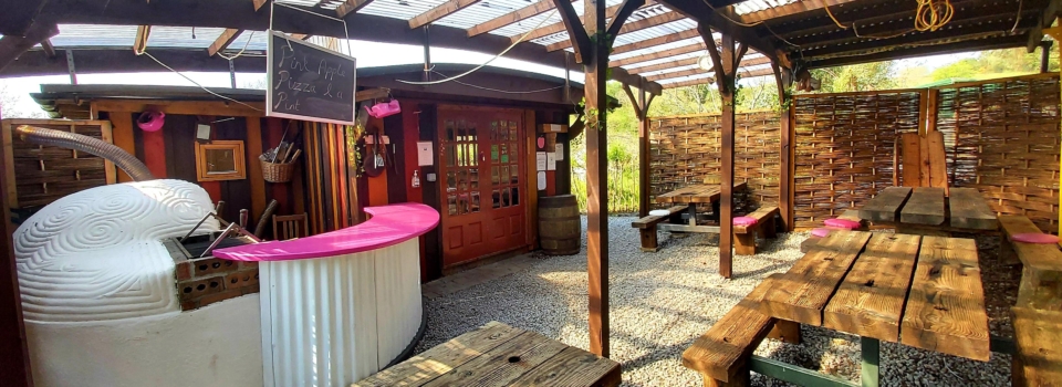 Pink Apple orchard ireland glamping, outdoor dining, pizza oven, communal area